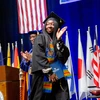 student walking across the platform at Commencement