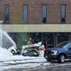 skid steer with snowblower plowing near Mason Hall